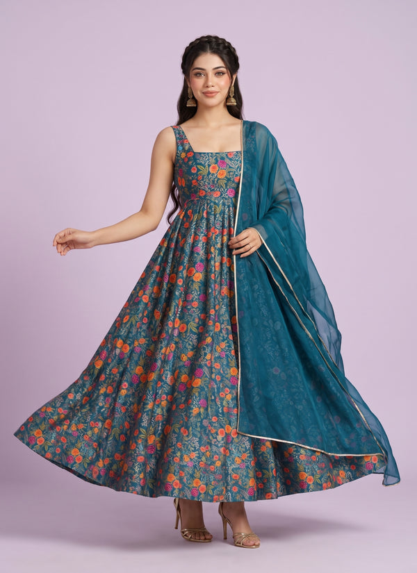 Model in a teal floral print sleeveless silk anarkali gown with teal organza dupatta – full length twirl