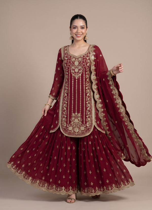Model twirling in the maroon georgette sharara with gold buttis and scalloped border