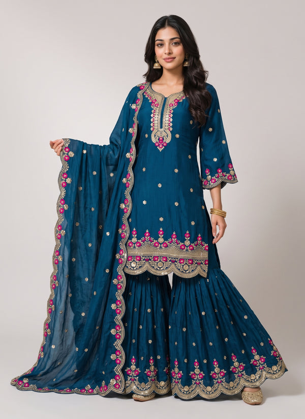 Peacock teal Rangoli crush sharara suit with gold sequin and pink rose embroidery, scalloped kurti hem, flared sharara and embroidered dupatta, front view