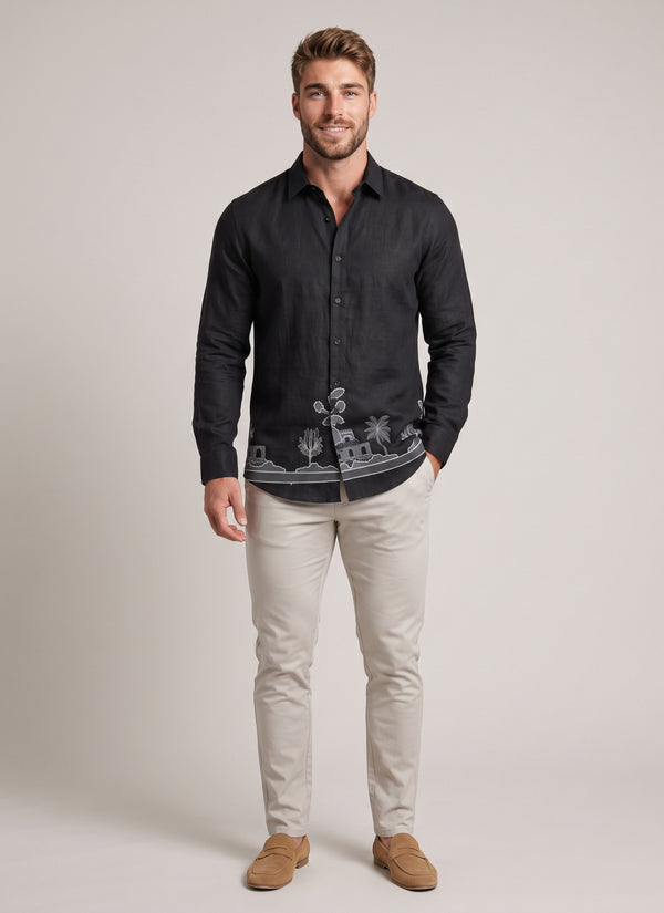 Man wearing a black linen embroidered shirt for men with stone chinos