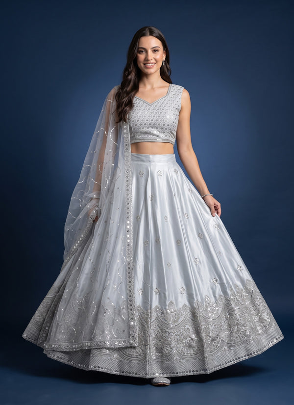 Model in an ice grey lehenga choli with a honeycomb sequin blouse and sheer net dupatta, front view