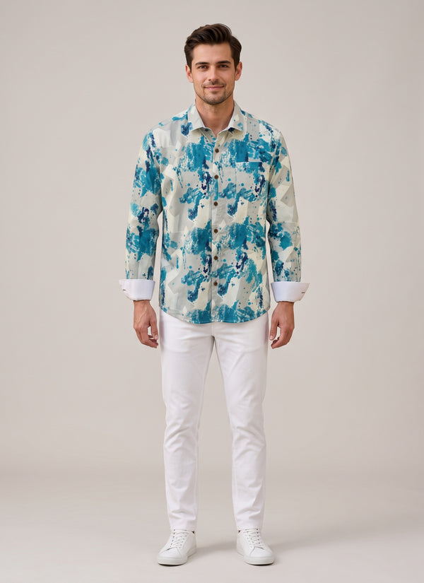 Man wearing a teal splash designer printed shirt for men with white chinos