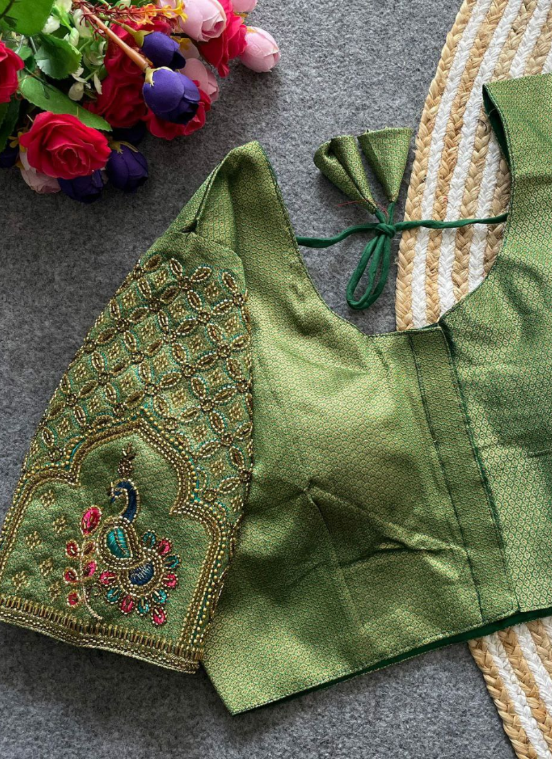 This exclusive partywear blouse is crafted from heavy Banarasi Jacquard silk with tricot fusing