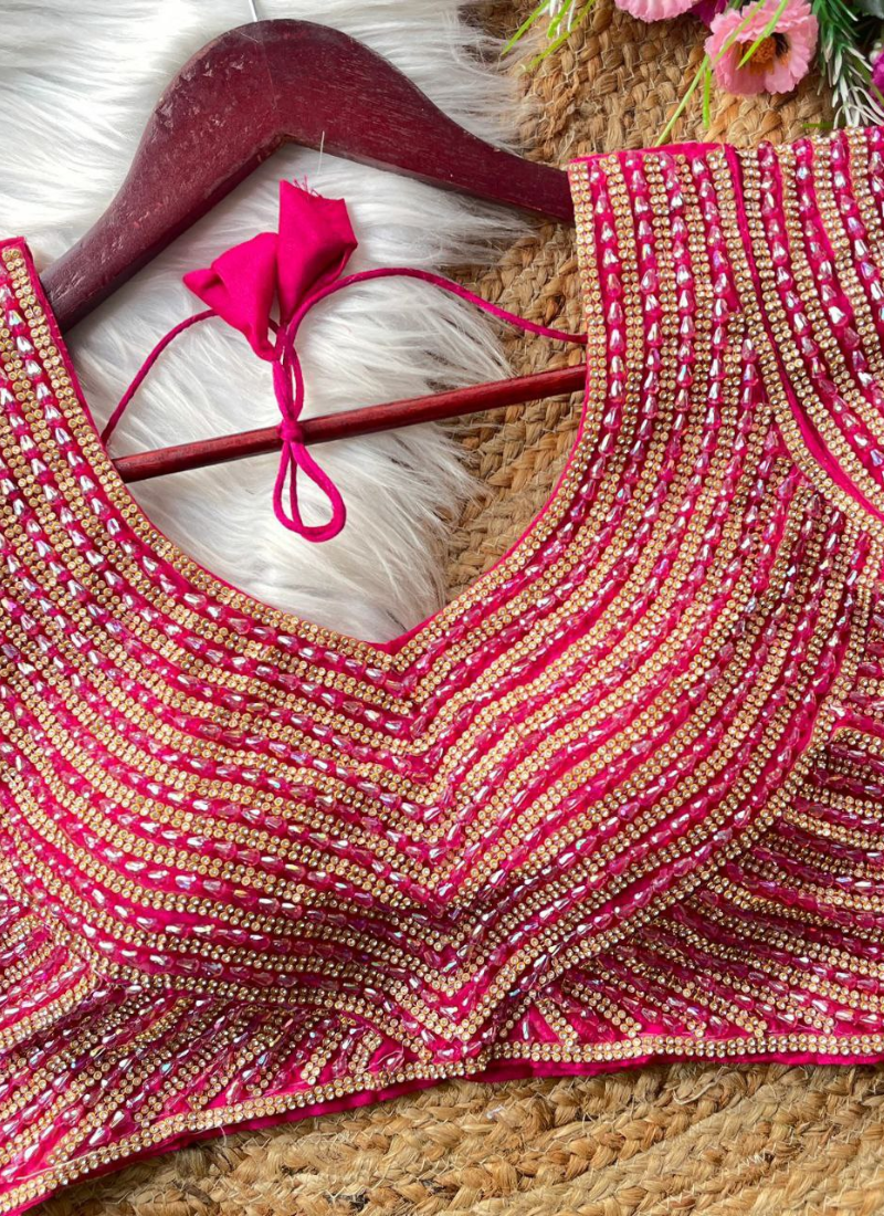 Elegant women’s blouse in pure silk with heavy hand embroidery, attached sleeves, and premium stitching.