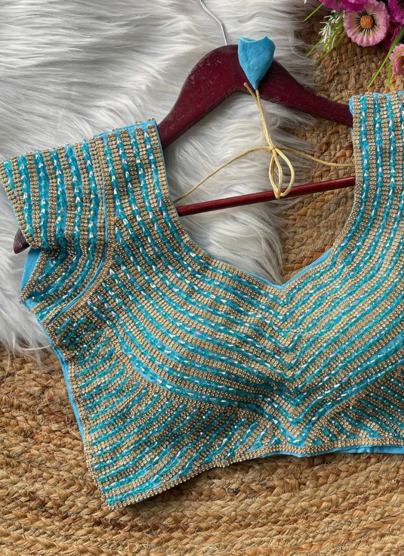 Elegant women’s blouse in pure silk with heavy hand embroidery, attached sleeves, and premium stitching.