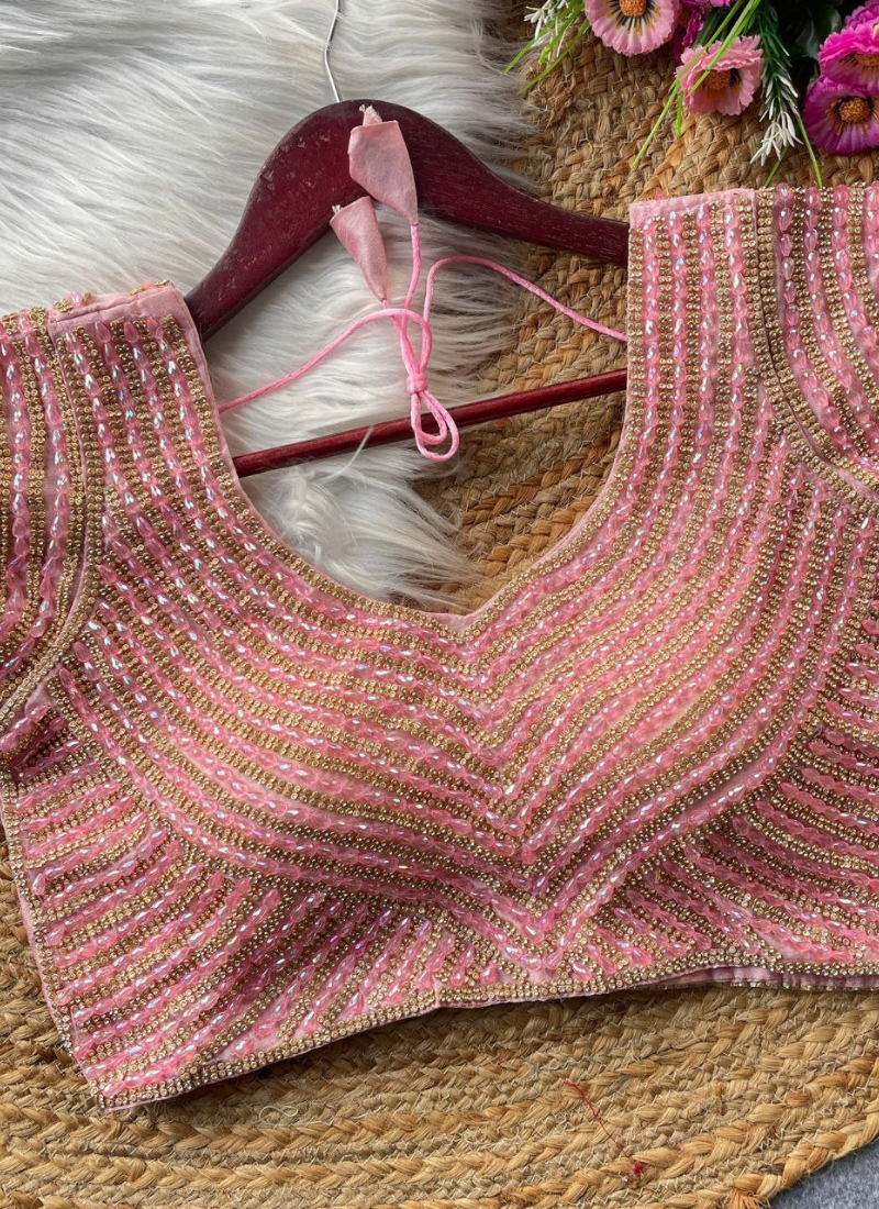 Elegant women’s blouse in pure silk with heavy hand embroidery, attached sleeves, and premium stitching.