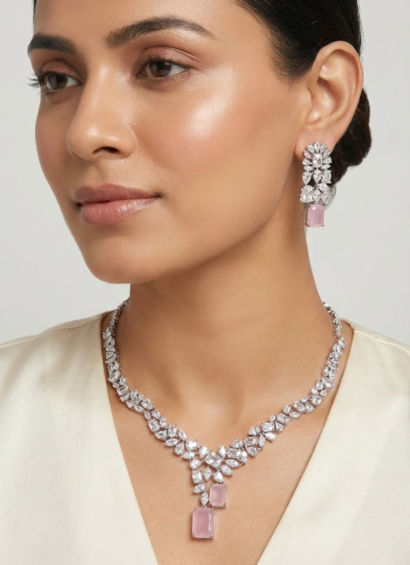 Diamond cut necklace and earring set with premium pink stone centerpiece, bridal jewelry in silver finish.