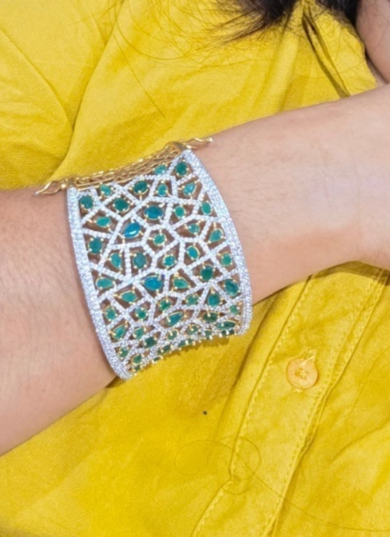Luxury diamond bracelet for women with premium stone setting, white and green stones for festive occasions.