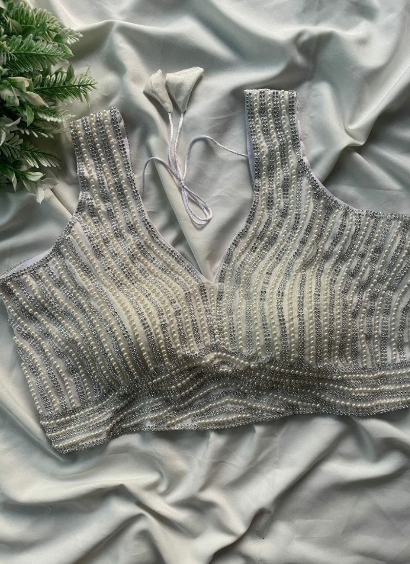 Statement sleeveless blouse in pure silk with heavy stitching, back open design, and cotton lining.