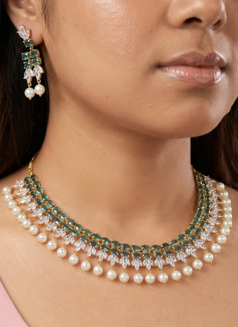 Luxury diamond cut necklace and earring set with high‑quality stone setting and green gemstone centerpiece.