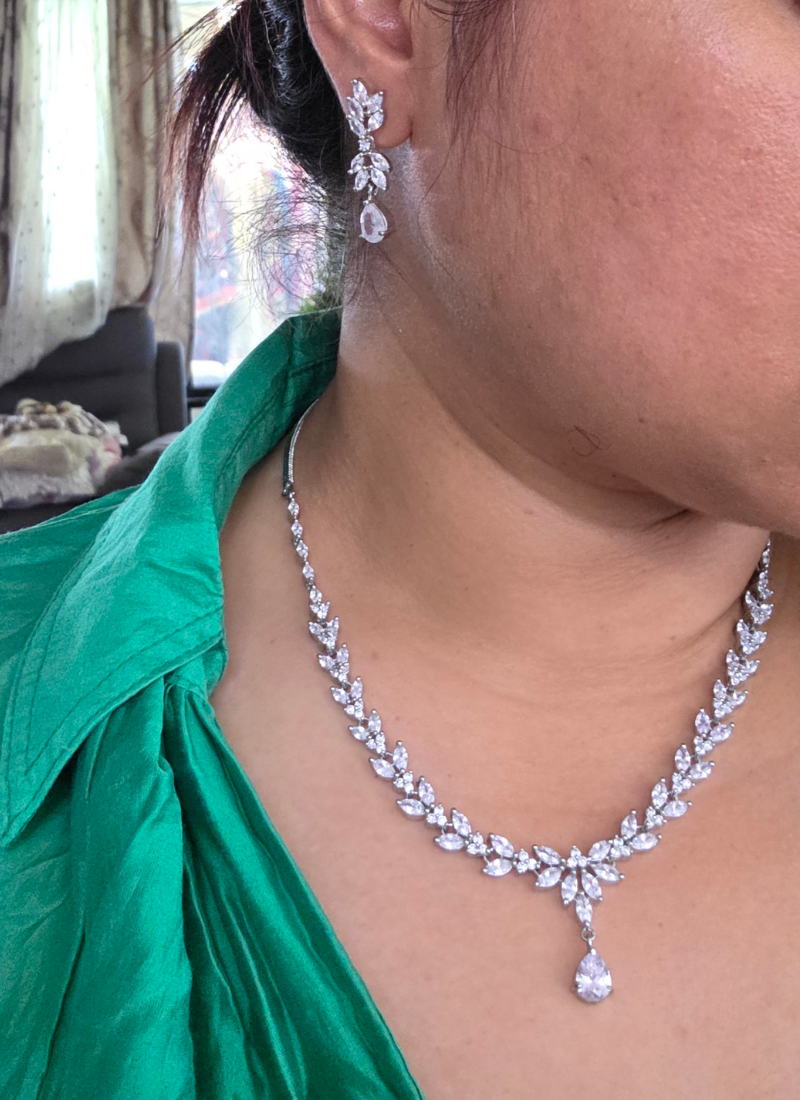 Bridal necklace set with earrings in silver finish, diamond cut stones in premium stone setting.