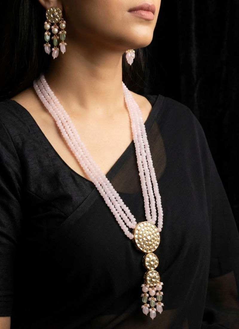 Elegant long necklace set featuring kundan stones and light pink bead detailing, partywear jewelry for women.

