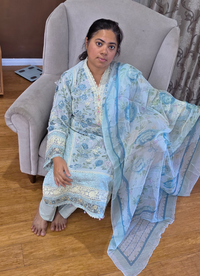 Elegant Indian salwar kameez in light ash pest chiffon with chikankari detailing and premium embroidery.