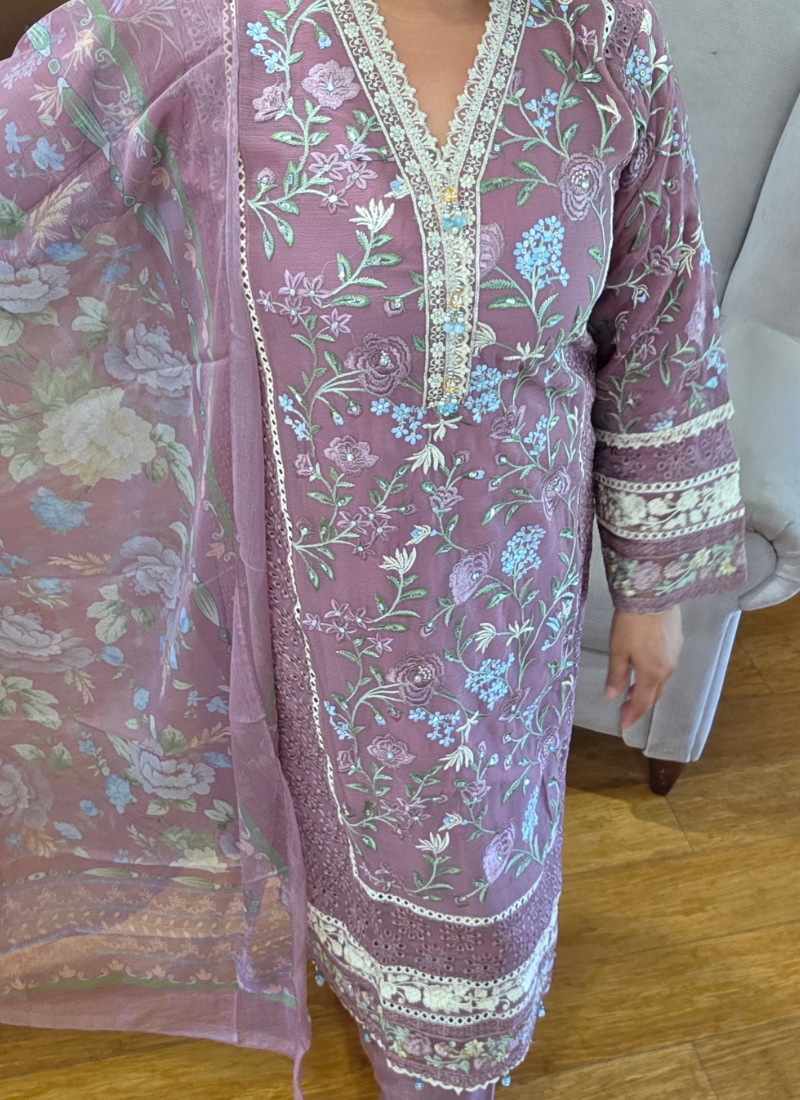 Statement light purple salwar kameez with tassels, lace work, and chikankari embroidery on both sides.
