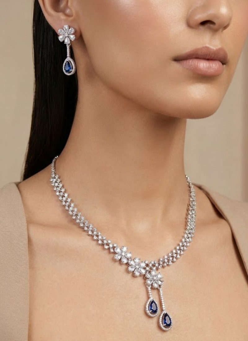 Elegant necklace set with earrings featuring diamond cut stones and blue stone accent, partywear bridal jewelry.
