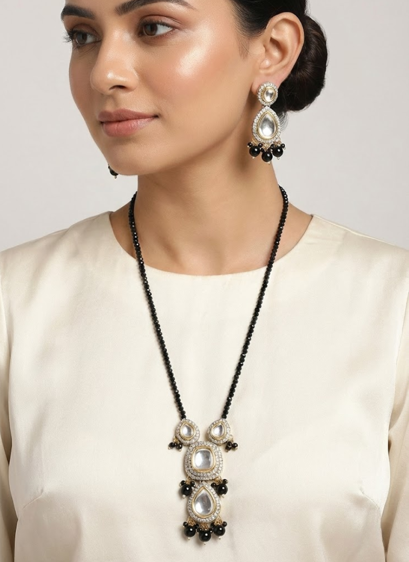 Long necklace and earring set with kundan and stone setting, accented with black beads, bridal jewelry.