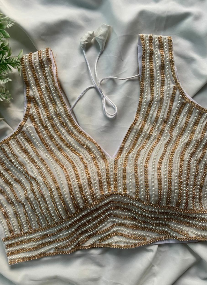 Luxury bridal blouse with heavy pearl embroidery, sleeveless style, padded fit, and 4 color options.