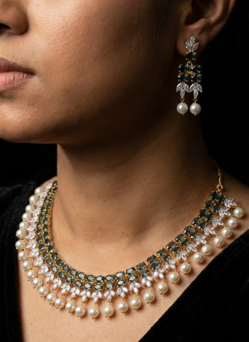 Bridal necklace set with earrings in silver finish, diamond cut stones and striking green stone centerpiece.