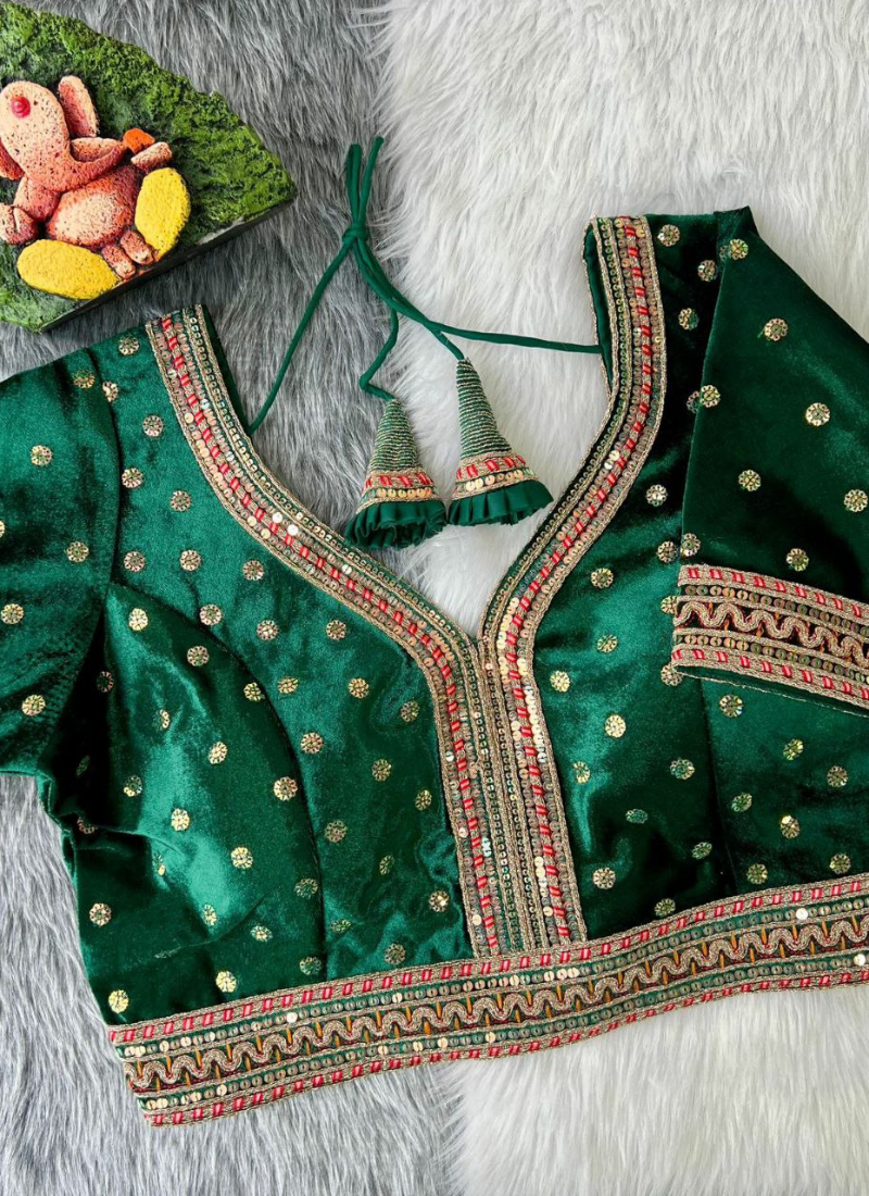 Statement wedding blouse in velvet with heavy stitching, glitter sequence embroidery, and traditional detailing.