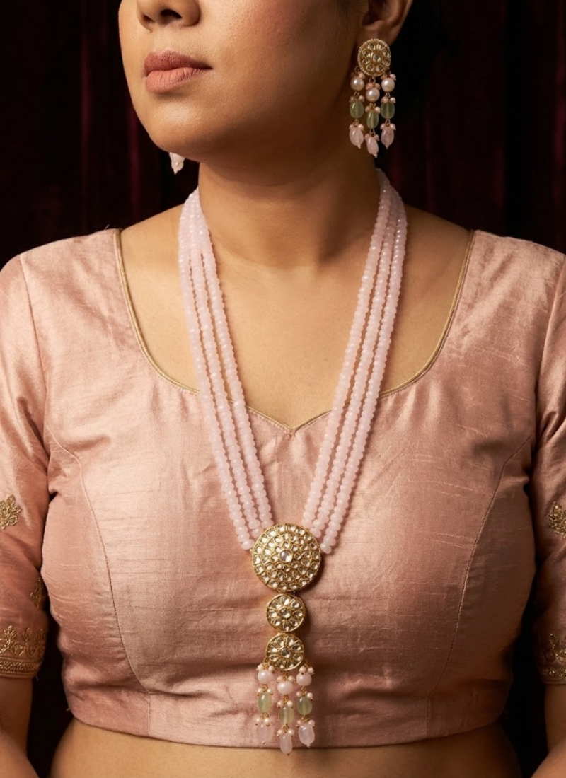 Statement long necklace and earring set in gold finish, kundan and stone setting with delicate pink beads.