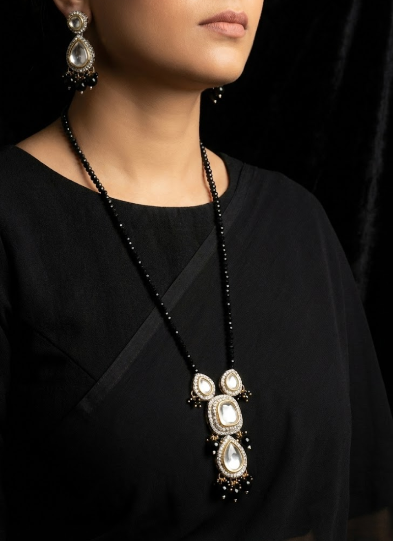 Elegant long necklace set featuring kundan stones and black bead detailing, partywear jewelry for women.