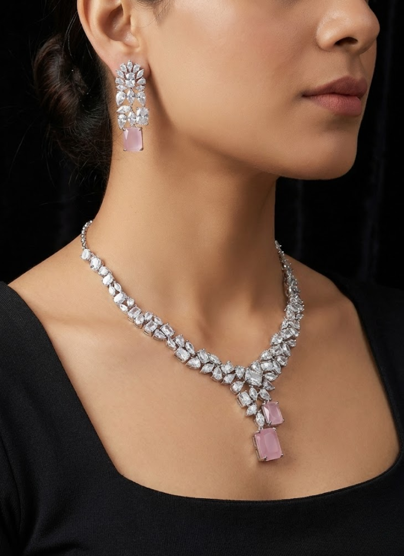 Bridal necklace set with earrings in silver finish, diamond cut stones and striking pink stone centerpiece.