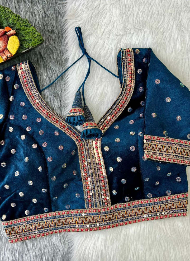 Statement wedding blouse in velvet with heavy stitching, glitter sequence embroidery, and traditional detailing.