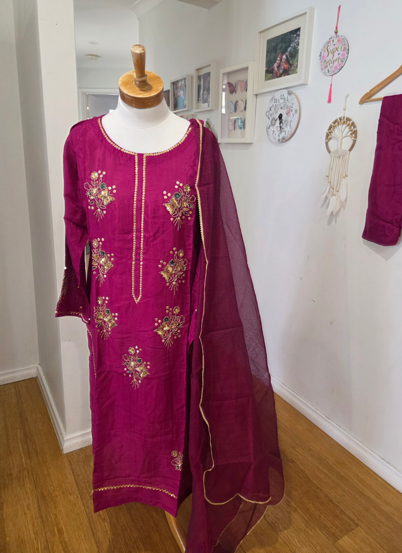 Hot magenta silk salwar kameez with zari and sequence handwork, Kota net dupatta, and sleeve detailing.
