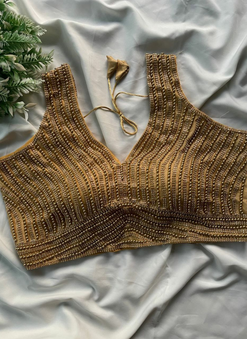 Women’s pure silk blouse with sleeveless cut, heavy pearl work, padded fit, and traditional detailing.