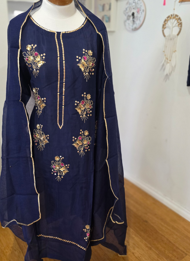 Statement navy blue silk salwar kameez with hand embroidery, padded fit, and Pakistani size options.