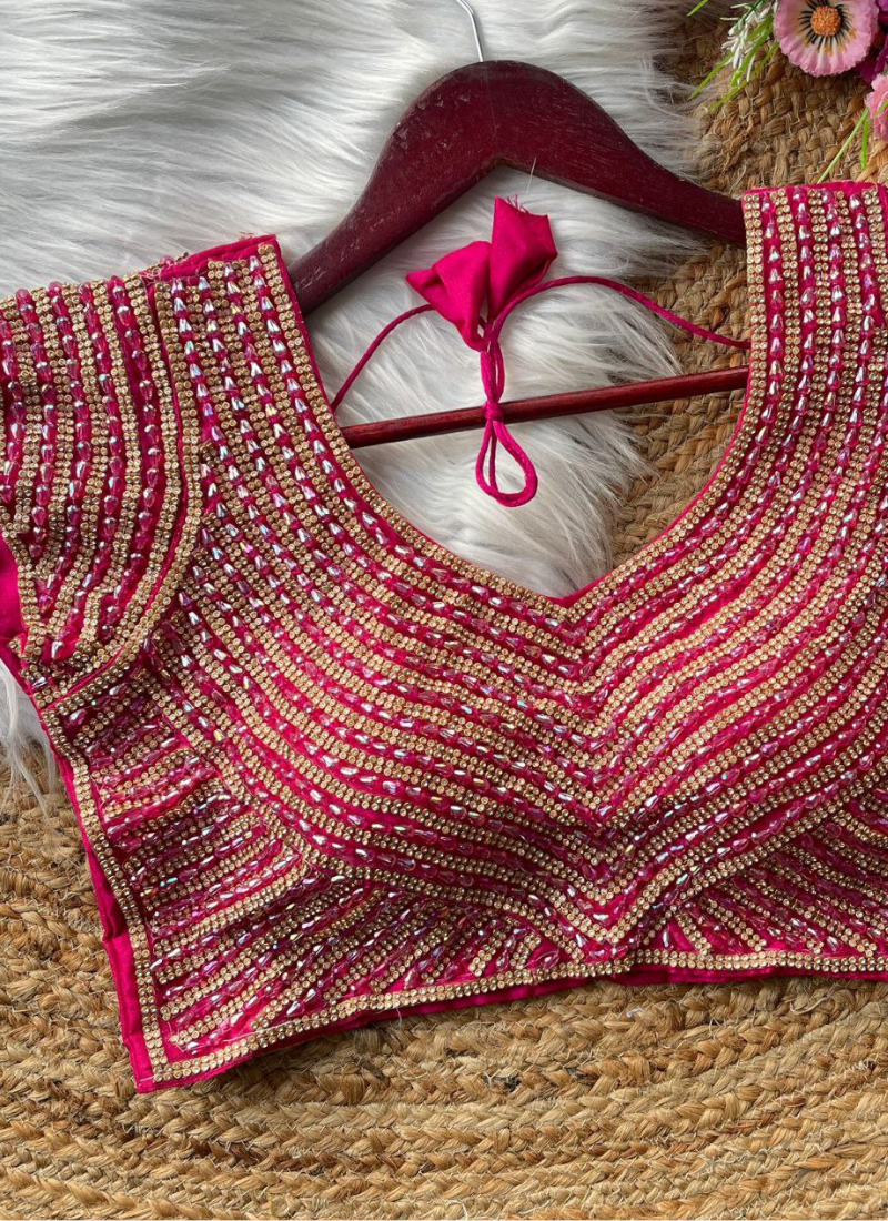 Elegant women’s blouse in pure silk with heavy hand embroidery, attached sleeves, and premium stitching.