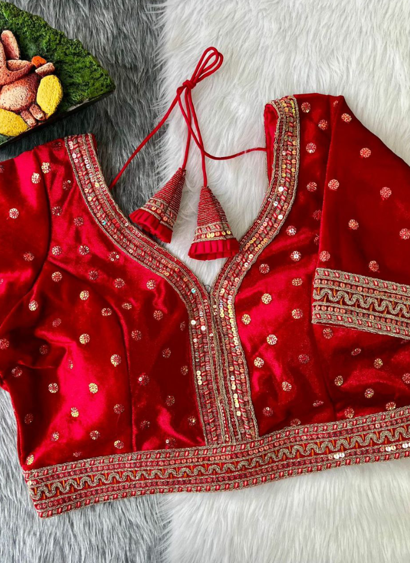 Statement wedding blouse in velvet with heavy stitching, glitter sequence embroidery, and traditional detailing.