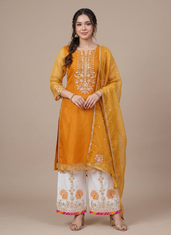 Close-up of the mustard organza kurti yoke with zari placket, pink flowers and paisley motif