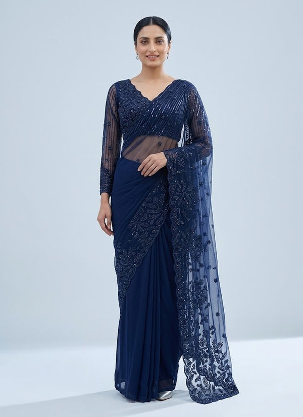 Navy blue georgette saree with sequin embroidered net pallu and full sleeve stitched blouse, front view