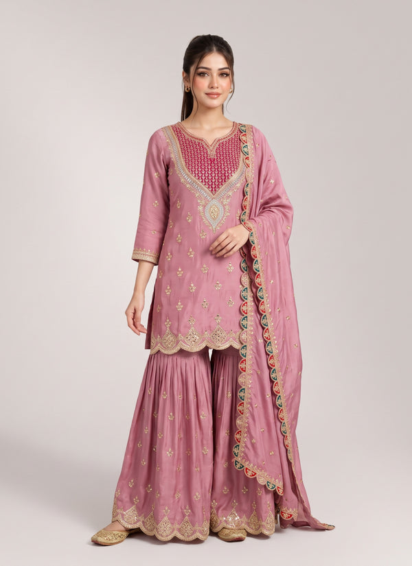 Onion pink chinon silk sharara suit with rani pink sequin and mirror V yoke, diamond stone medallion, scalloped gold hems and multicolour border dupatta, front view