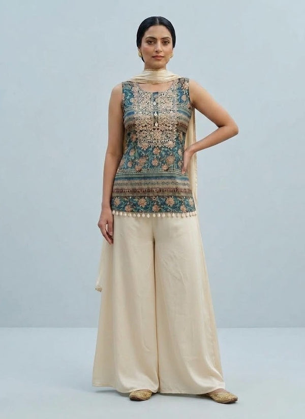 Teal and cream satin palazzo set with printed sleeveless kurti, cowrie shell tassels and cream dupatta, front view