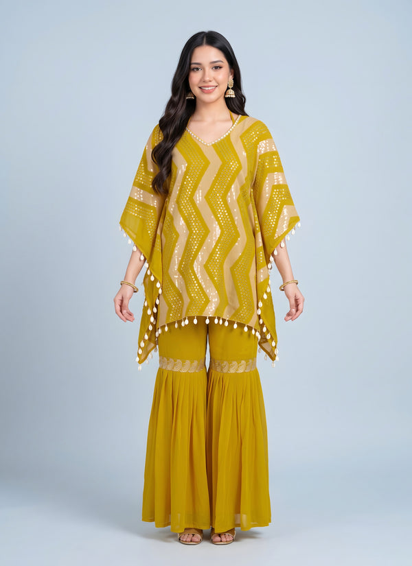 Haldi yellow kaftan sharara set with zig-zag sequin stripes and cowrie shell tassels – front view